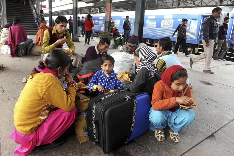 Indian Railways carried 8.224 billion originating passengers in 2012, with an average travel distance of 127.2 kilometres. Narinder Nanu / AFP