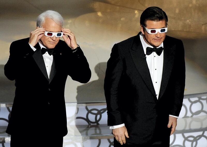Comedian Steve Martin (L) and actor Alec Baldwin, don 3-D glasses as they co-host the 82nd Academy Awards at the Kodak Theater in Hollywood, California on March 7, 2010. AFP PHOTO Gabriel BOUYS (Photo by GABRIEL BOUYS / AFP)