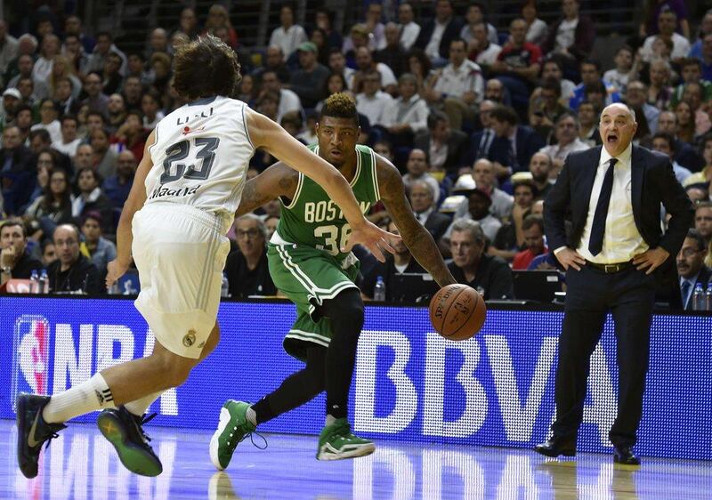 Real Madrid’s Sergio Llull guards Marcus Smart of the Boston Celtics during their pre-season game in Madrid on Thursday night. Gerard Julien / AFP