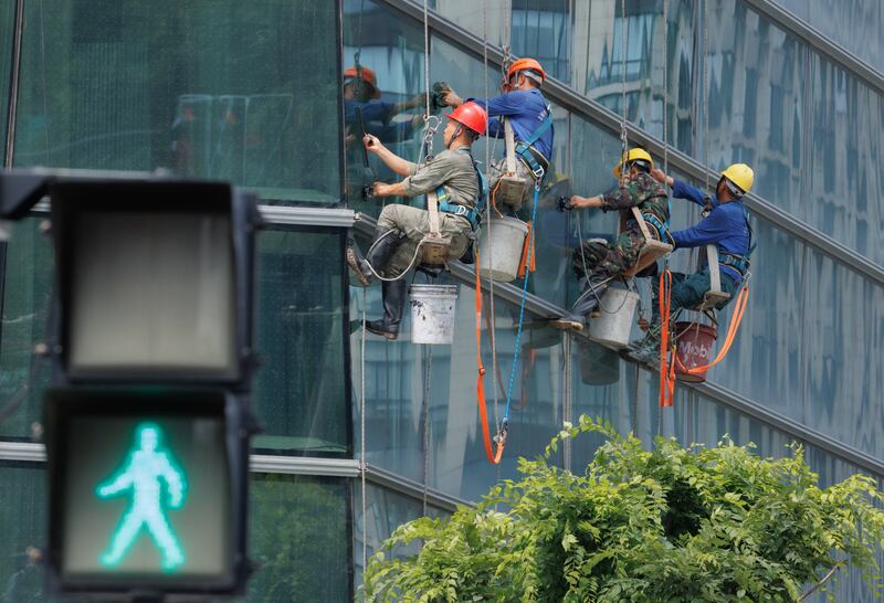 The windows of a high-rise are washed  in Shanghai. China's annual inflation rate edged up to 0.2 per cent in May 2023, from April's 26-month low of 0. 1 percent. EPA