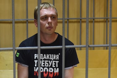 Russian investigative journalist Ivan Golunov, charged with attempted drug-dealing, sits inside a defendants' cage during a hearing at a court in Moscow on June 8, 2019. / AFP / Vasily MAXIMOV