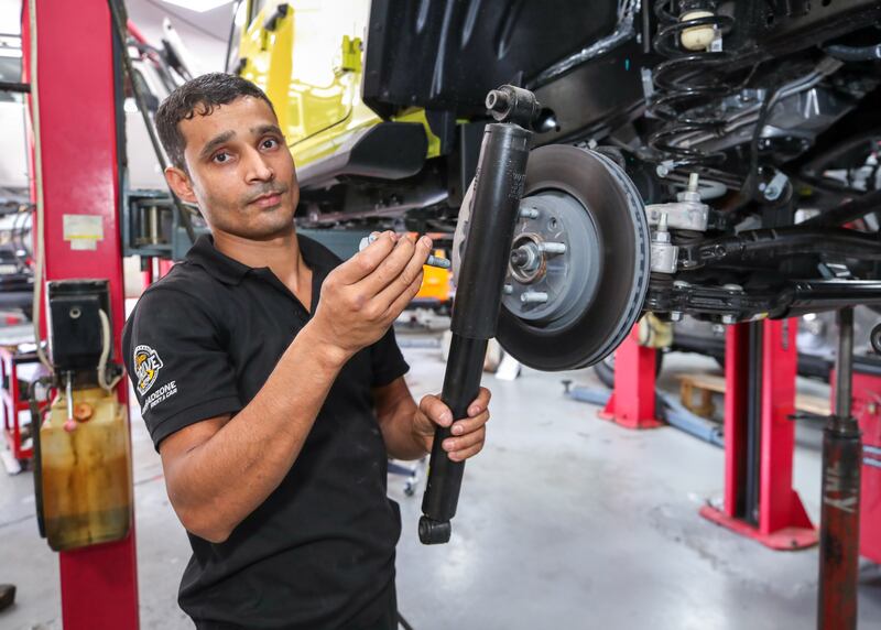 A mechanic who specialises in suspension removes a Wrangler's regular shock absorbers