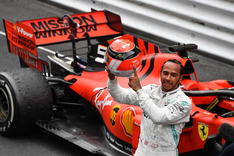 Mercedes' British driver Lewis Hamilton points at the name of late Formula One legend Niki Lauda on his helmet after winning the Monaco Formula 1 Grand Prix at the Monaco street circuit on May 26, 2019 in Monaco. (Photo by Yann COATSALIOU / AFP)