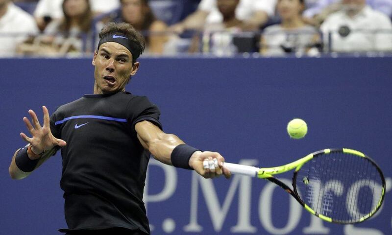 Rafael Nadal hits a return to Andrey Kuznetsov. Jason Szenes / EPA