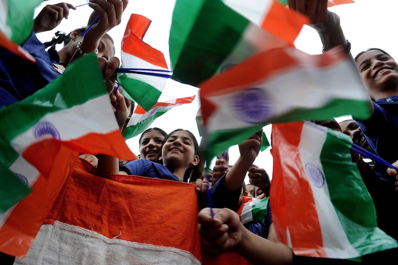 Indian schoolgirls wave Indian flags during a rehearsal for Independence Day parade celebrations at a school in Amritsar on August 11, 2010.  India's Independence Day is celebrated on August 15 to commemorate its independence from British rule in 1947.    AFP PHOTO/ NARINDER NANU *** Local Caption ***  169972-01-08.jpg