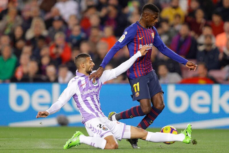 Barcelona's Dembele is tackled by Real Valladolid's Joaquin Fernandez. AP Photo