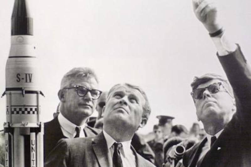 FILE - In this Nov. 16, 1963 NASA photo provided by the John F. Kennedy Library and Museum deputy Administrator of NASA Dr. Robert Seamans, left, and Dr. Wernher von Braun, center, look on as President John F. Kennedy, right, points upward at Cape Canaveral Air Force Station, in Florida. The John F. Kennedy Library on Wednesday released a tape recording of a 73-minute meeting in which Kennedy insists to NASA officials that the United State's top space priority should be beating the Russians to the moon. The first landing of a human being on the moon on July 20, 1969 celebrate its 40th anniversary this year 2009. (AP Photo/NASA via John F. Kennedy Library and Museum, File) * EDITORIAL USE ONLY * NO SALES *