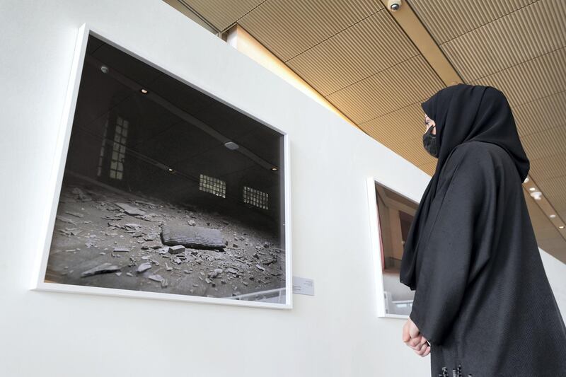 Sharjah, United Arab Emirates - December 10, 2020: News. Arts. A visitor looks at a picture as part of The Ashes series. Opening of the House of Wisdom, a high tech new library. Thursday, December 10th, 2020 in Sharjah. Chris Whiteoak / The National