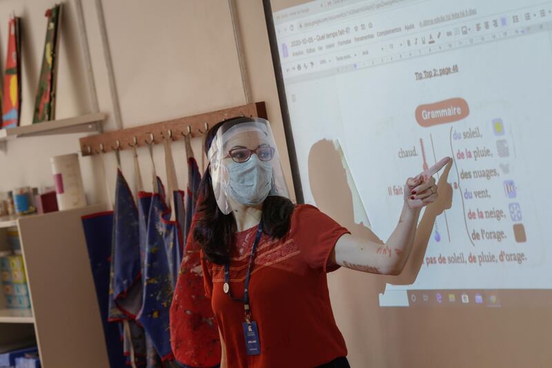 A teacher wearing a protective mask and face shield speaks during a French lesson at a school in Rio de Janeiro, Brazil, on Monday, Oct. 5, 2020. As officials begin to reopen large parts of the country, the number of confirmed cases in the coronavirus outbreak in Brazil stands at 4.92 million, with spikes not seen slowing. Photographer: Andre Coelho/Bloomberg