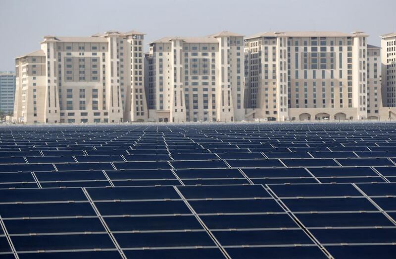 Above, a solar farm on the outskirts of Masdar City. The UAE is spending Dh600 billion over the next 33 years to integrate renewable, nuclear and clean fossil energy as part of its 2050 energy plan. Karim Sahib / AFP