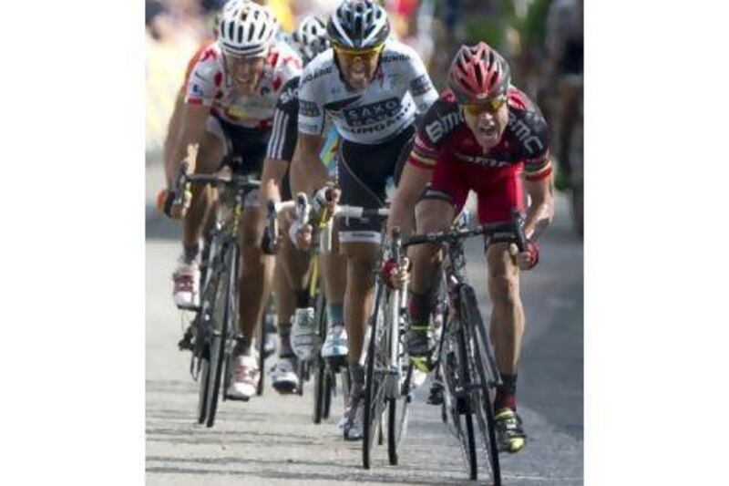 Cadel Evans, right, held off a charge by the three-time Tour de France winner Alberto Contador, centre, and Belgium's Philippe Gilbert, left, to win the fourth stage yesterday. Thor Hushovd remains the overall leader.