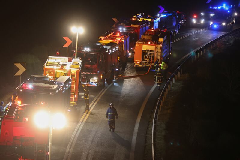 Firefighters and rescuers at the site of the crash. Reuters