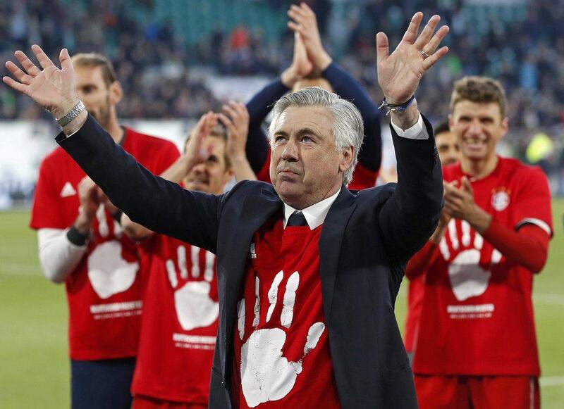 Bayern Munich manager Carlo Ancelotti, centre, celebrates with his players after winning the German Bundesliga match against Wolfsburg  in Wolfsburg, Germany, 29 April 2017. Bayern won the match with 6-0 to clinch their unprecedented fifth consecutive Bundesliga league title. Felipe Trueba / EPA