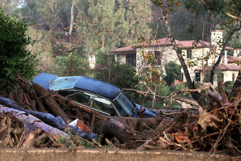 A car is piled up in debris after a mudslide trapped it  after heavy rains in Montecito, California. Mike Nelson / EPA