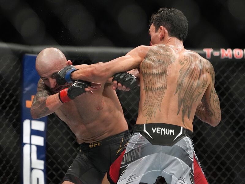 Max Holloway lands a punch on Alexander Volkanovski during their bout at during UFC 276. Reuters