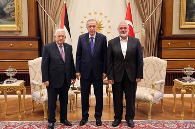 Palestinian President Mahmoud Abbas, left, and the leader of the Palestinian Hamas movement Ismail Haniyeh, right, meet Turkish President Recep Tayyip Erdogan in Ankara. AFP