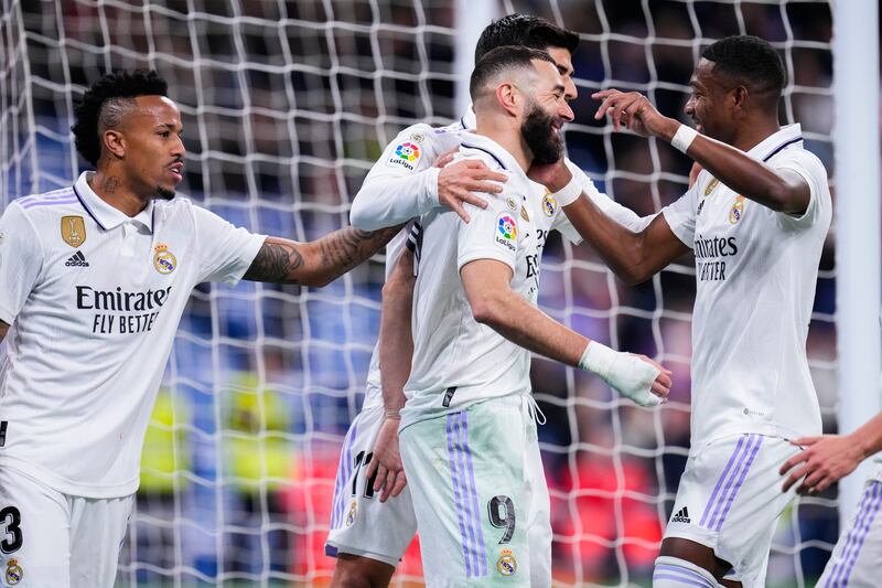 Real Madrid's Karim Benzema, centre, is congratulated after scoring his side's second goal from the penalty spot. AP Photo