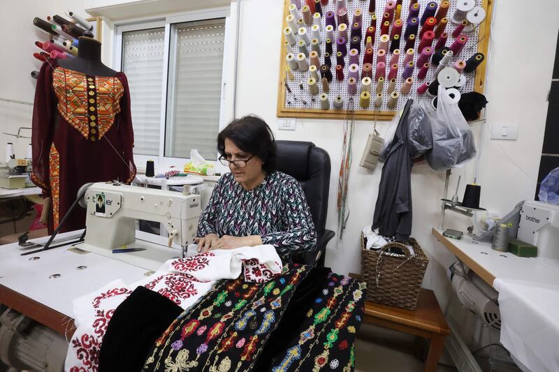 A worker sews at Khawla al-Tawil's fashion shop.