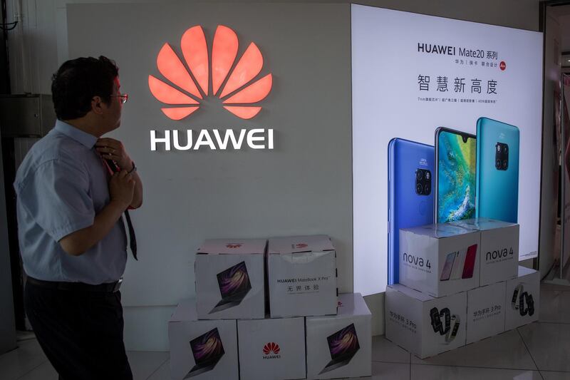 epa07586410 A man walks next to a Huawei logo in a shopping mall in Beijing, China, 20 May 2019. According to media reports on 20 May 2019, the US based multinational technology company Google halted business with Huawei in the wake of the Trump administration adding the Chinese telecommunication company to a trade blacklist over national security concerns. Huawei will lose access to updates for the Android operating system.  EPA-EFE/ROMAN PILIPEY *** Local Caption *** 55208626