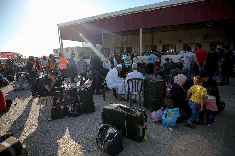 Palestinians wait to cross into Egypt through the Rafah border crossing between Gaza Strip and Egypt after five months of closure.  EPA