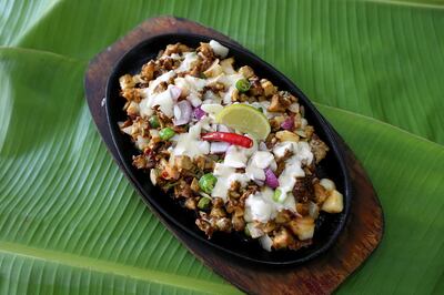 Dubai, United Arab Emirates-May,13,2016: Filipino Dish Chicken Sisizling Sisig at the Little Manila Restaurant  a Filipino restaurants on Muraqqabat Road near Deira  in Dubai . ( Satish Kumar / The National  ) 
ID No: 65753
Section: Arts & Life
Reporter : Stacie  Johnson *** Local Caption ***  SK-LittleManila-13052016-012.jpg