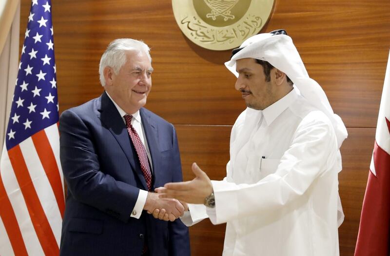 Qatari Foreign Minister Mohammed bin Abdulrahman al-Thani (R) greets US Secretary of State Rex Tillerson in the capital Doha on October 22, 2017. / AFP PHOTO / POOL AND AFP PHOTO / Alex Brandon