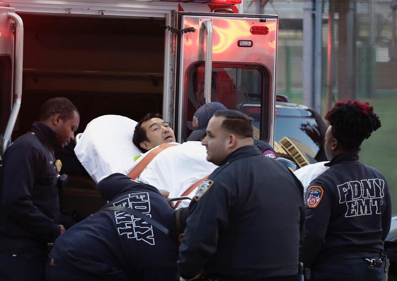 Emergency personnel carry a man into an ambulance after a motorist drove onto a busy bicycle path near the World Trade Center memorial and struck several people Tuesday, Oct. 31, 2017, in New York. (AP Photo/Mark Lennihan)