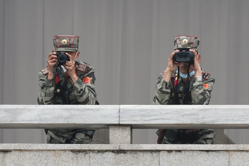North Korean soldiers look south while US ambassador to the UN Linda Thomas-Greenfield visits Panmunjom, in the Demilitarised Zone. EPA
