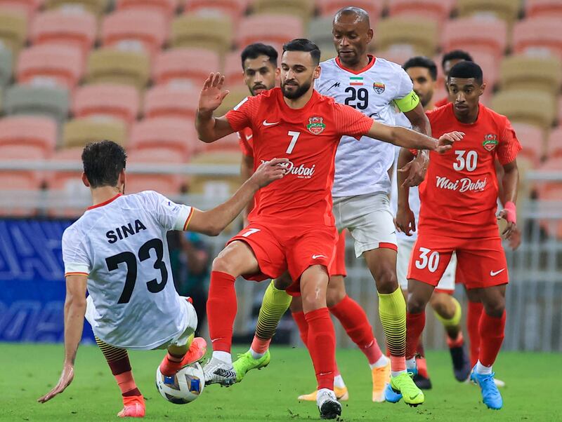 Shabab's midfielder Ahmad Nourollahi, centre, vies for the ball with Foolad's midfielder Sina Moridi during the AFC Champions League match at the King Abdullah Sports City stadium in Jeddah. AFP