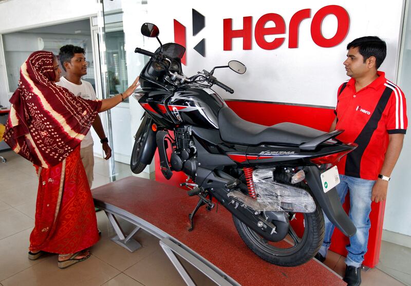 Customers look at a Hero MotoCorp Karizma motorbike at a showroom in Ahmedabad, India. The company has launched an electric scooter under the brand Vida. Reuters