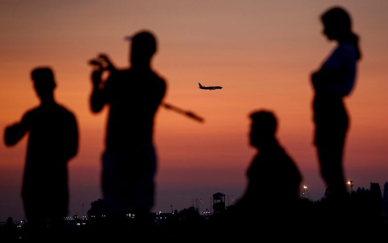 An aircraft is seen next to the people on the beach in Sochi as the number of the coronavirus disease cases grows in Russia. Reuters