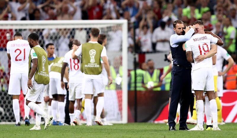 MOSCOW, RUSSIA - JULY 11: Gareth Southgate, Manager of England embraces Marcus Rashford of England and Phil Jones of England after the 2018 FIFA World Cup Russia Semi Final match between England and Croatia at Luzhniki Stadium on July 11, 2018 in Moscow, Russia.  (Photo by Ryan Pierse/Getty Images)