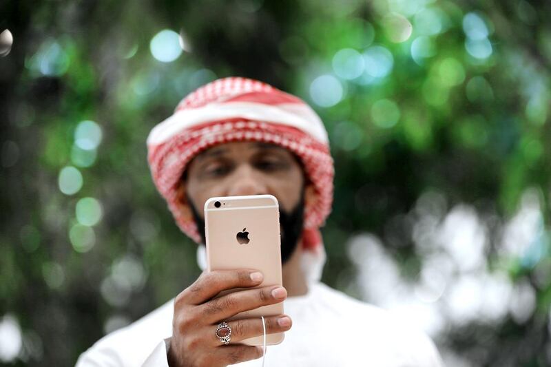 An iPhone is tested at the Apple Store ahead of its grand opening in Dubai in October. Kamran Jebreili / AP Photo