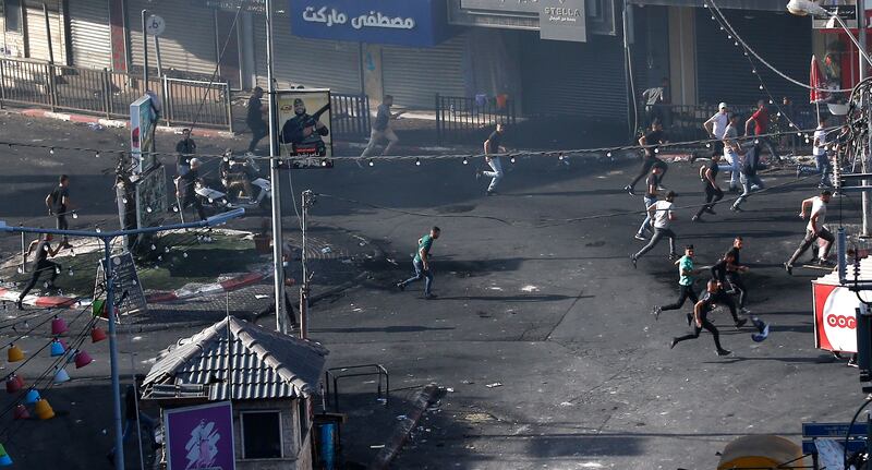 Palestinians run during clashes with the Israeli army on the second day of the military operation in Jenin camp. EPA