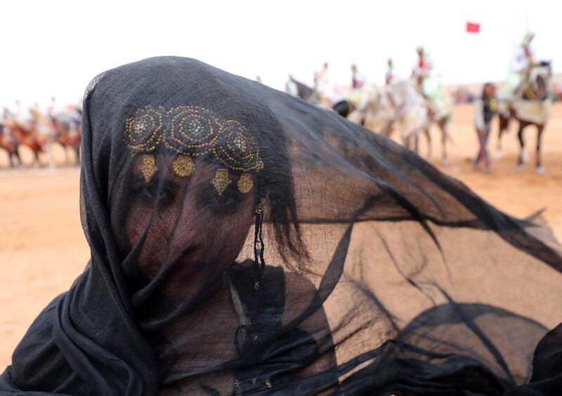 A Moroccan girl from the southern desert performs during a fantasia. AFP