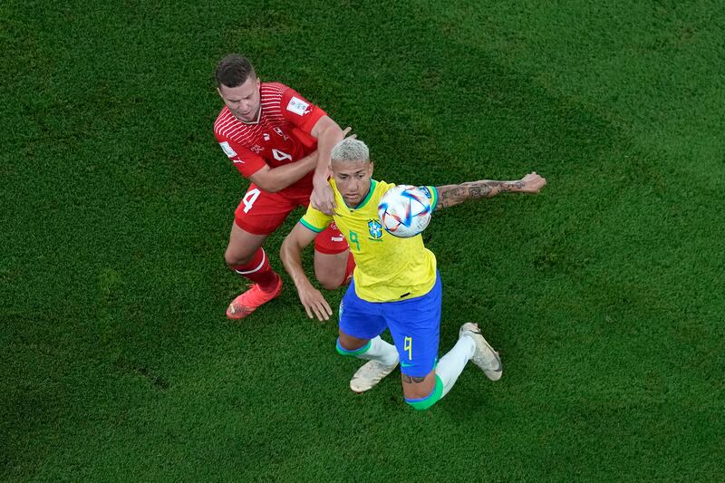 Brazil's Richarlison under pressure from Nico Elvedi of Switzerland. AP