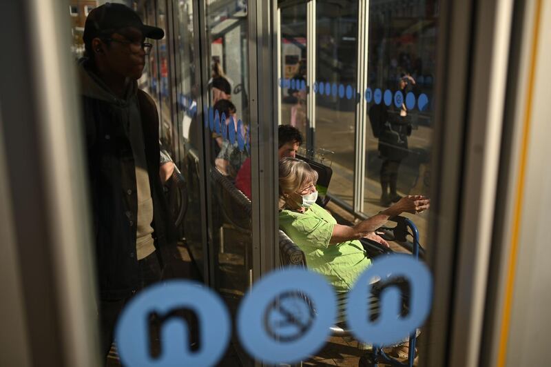 A woman waits in a bus stop in Solihull, central England. AFP