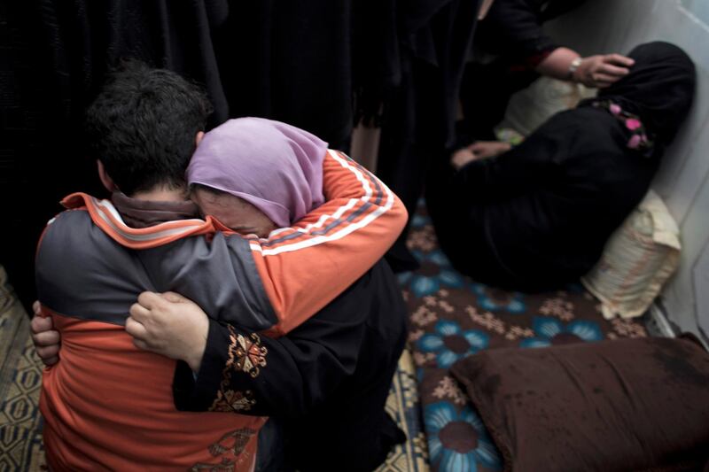 Relatives of Palestinian teenager Hassan Shalabi mourn his death at the family home during his funeral in Nuseirat refugee camp, central Gaza Strip. AP