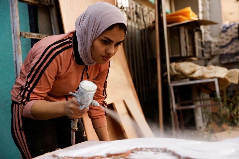 Noor Al Janabi works on a piece of furniture for a customer.