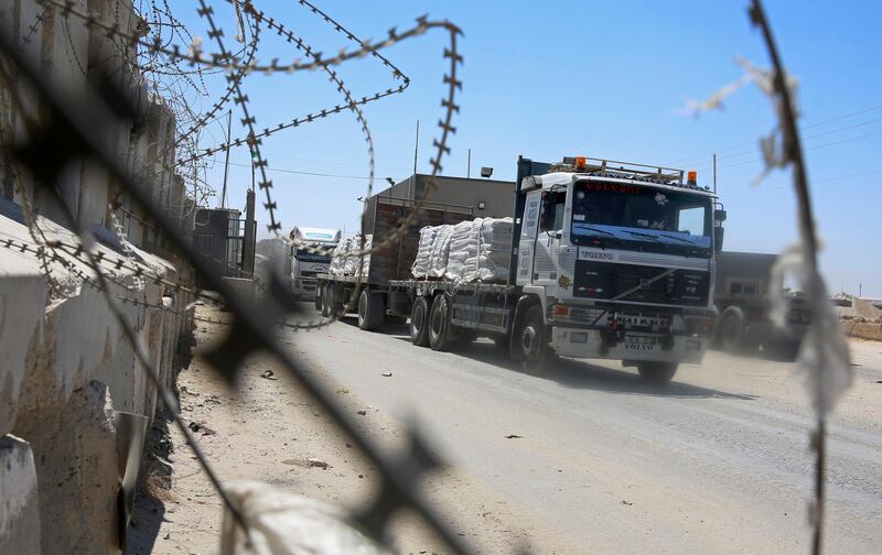 Trucks full of goods depart from the Palestinian side of the Kerem Shalom cargo crossing with Israel, in Rafah, southern Gaza Strip, Wednesday, Aug. 15, 2018. Israel on Wednesday opened its only cargo crossing with the Gaza Strip weeks after closing it amid a surge in violence with the Islamic militant group Hamas. The reopening of the Kerem Shalom crossing came as Egypt was stepping up efforts to broker a lasting cease-fire. (AP Photo/Adel Hana)