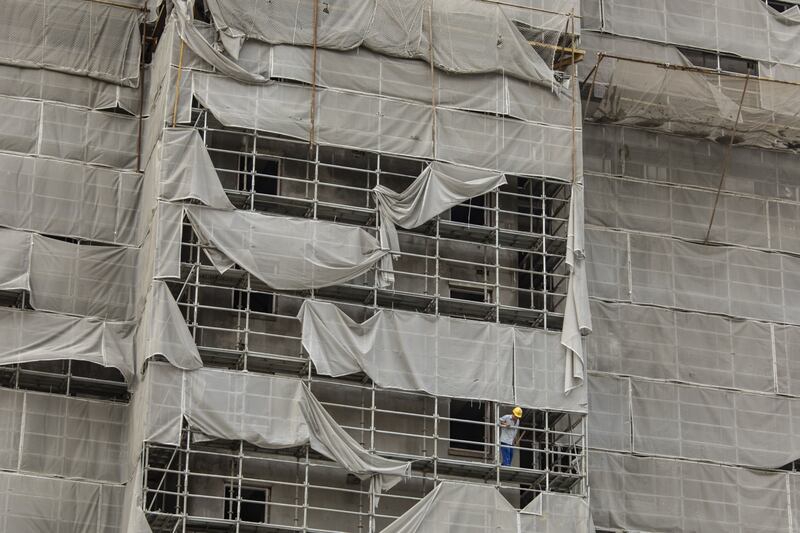 Scaffolding netting damaged by Typhoon In-Fa shrouds a building in Shanghai, China.