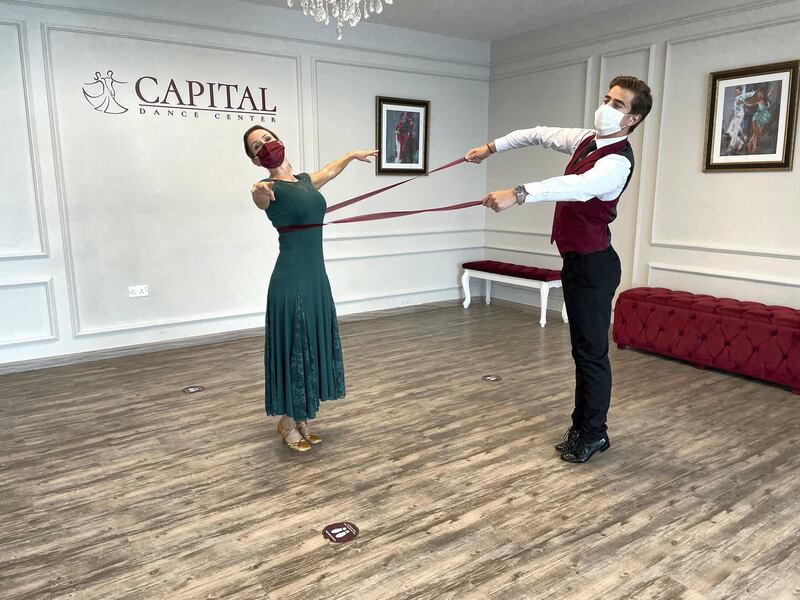 Sticks and ribbons were used so students could learn ballroom dancing while maintaining distance.