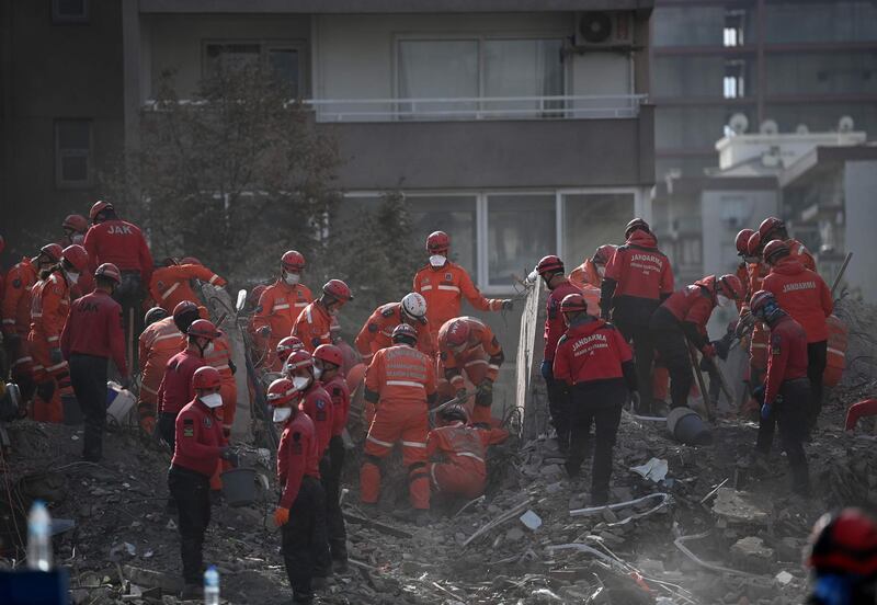 Rescue personnel search through the rubble of buildings at Bayrakli district in Izmir on November 3, 2020, as they look for survivors after a 7.0-magnitude earthquake struck Turkey and Greece on October 29.  A four-year-old girl was pulled from the rubble 91 hours early November 3, after a powerful earthquake hit western Turkey, killing more than 100 people, the local mayor and AFP reporters at the scene said. / AFP / OZAN KOSE
