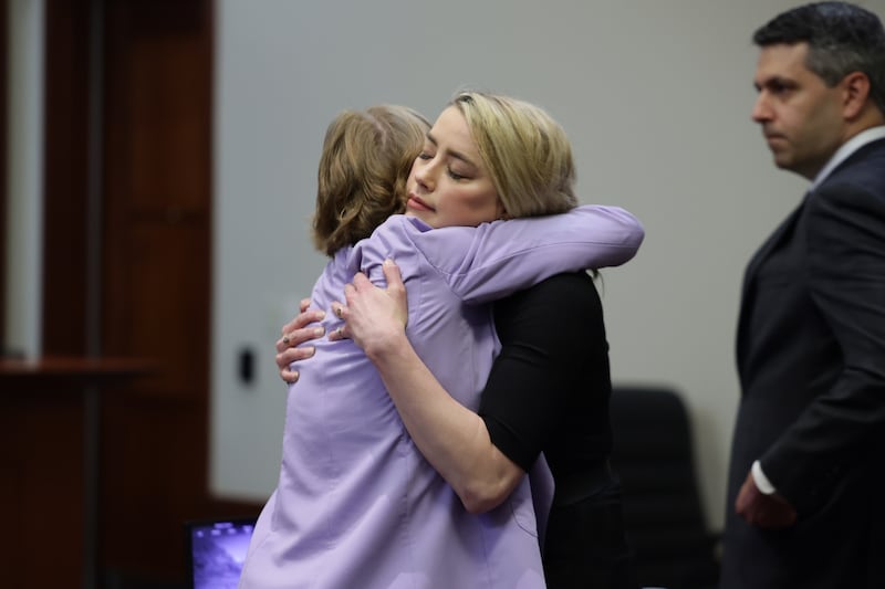 Amber Heard hugs her lawyer, Elaine Bredehoft, after the jury found her liable for defamation against her ex-husband, Johnny Depp on June 1, 2022. Pool / EPA