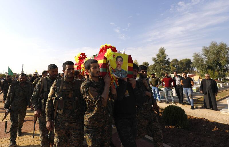 CORRECTION / Fighters from the Syrian Democratic Forces (SDF), carry the coffin of a fellow fighter  the funeral of a fellow fighter, killed during a military mission, in the Kurdish-controlled city of Qamishly in northeastern Syria, on November 11, 2018.   The Kurdish-led force SDF, joint Arab-Kurdish units backed by the US-led anti-jihadist coalition said today that it was resuming its offensive against the Islamic State (IS) group in eastern Syria. They had announced a suspension to their operation on October 31 after Turkey shelled Kurdish militia posts in northern Syria.
 / AFP / Delil SOULEIMAN
