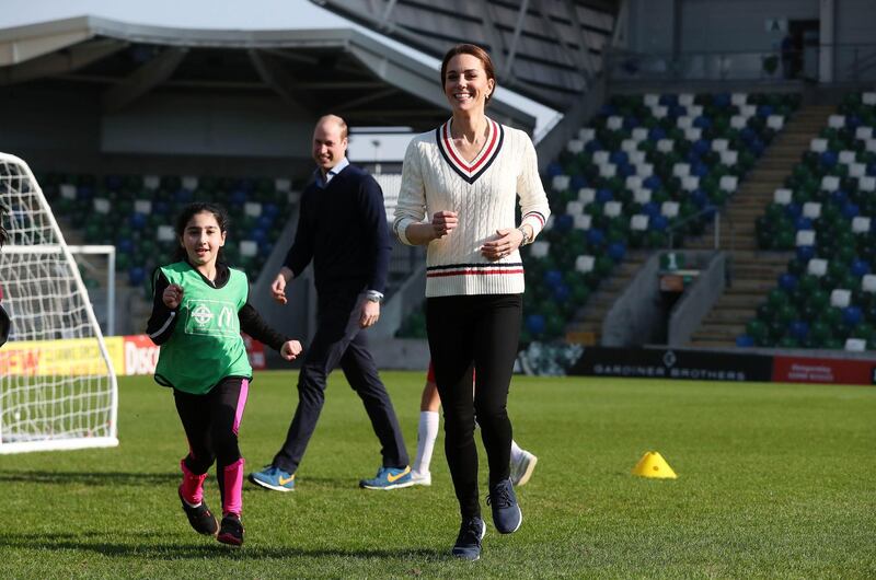 BELFAST, NORTHERN IRELAND - FEBRUARY 27:  Prince William Duke of Cambridge and Catherine, Duchess of Cambridge, play football during a visit the National Stadium in Belfast, home of the Irish Football Association on February 27, 2019 in Belfast, Northern Ireland. Prince William last visited Belfast in October 2017 without his wife, Catherine, Duchess of Cambridge, who was then pregnant with the couple's third child. This time the couple concentrate on the young people of Northern Ireland. Their engagements include a visit to Windsor Park Stadium, home of the Irish Football Association, activities at the Roscor Youth Village in Fermanagh, a party  at the Belfast Empire Hall, Cinemagic -a charity that uses film, television and digital technologies to inspire young people and finally dropping in on a SureStart early years programme. (Photo by Kelvin Boyes -  Pool/Getty Images)