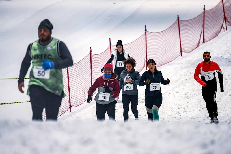 Participants race in the DXB Snow Run at Ski Dubai on August 14, 2020. AFP