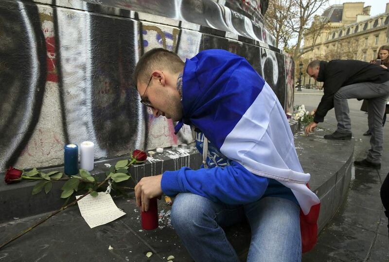 Candles in the French national colours are placed at Place de la Republique near the Bataclan concert hall. Pascal Rossignol/Reuters