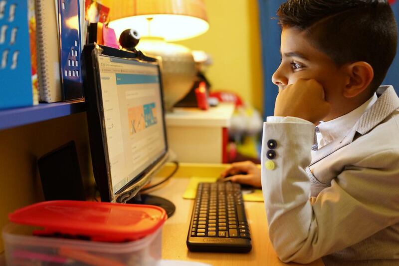 Yacoub Ali, 9, focuses on solving maths equations at his home in Abu Dhabi. Yacoub is one of the children given brain training by Dots & Links. Delores Johnson / The National