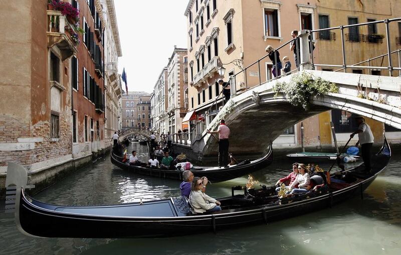 Above, gondolas with tourists in a canal in Venice. In 2018, Italians are expected to make 20 million trips abroad and spend €22.2 billion. Stefano Rellandini / Reuters